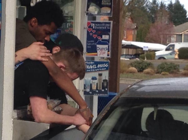 3 Dutch Bros Employees praying, zoomed in. 