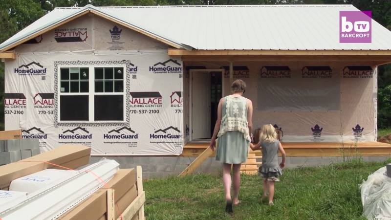 Courtney, Caroline and their beautiful new home. Image via YouTube.