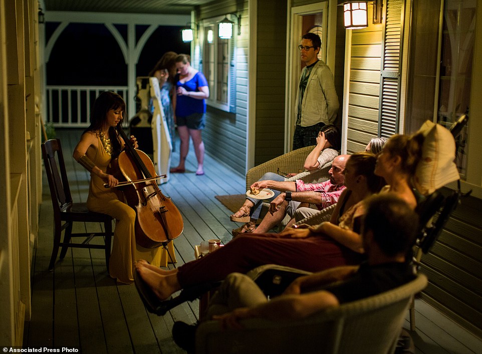 This July 23, 2016 photo provided by Niels Alpert, Kestrin Pantera plays her chello at a going away party for her friend Betsy Davis in Ojai, Calif. In early July, Davis emailed her closest friends and family to invite them to a two-day celebration, telling them: "These circumstances are unlike any party you have attended before, requiring emotional stamina, centeredness, and openness. And one rule: No crying." The 41-year-old woman diagnosed with ALS, held the party to say goodbye before becoming one of the first California residents to take life-ending drugs under a new law that gave such an option to the terminally ill. (Niels Alpert via AP)