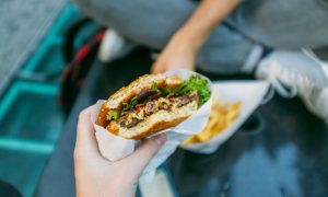 Cropped Image Of Woman Holding Burger