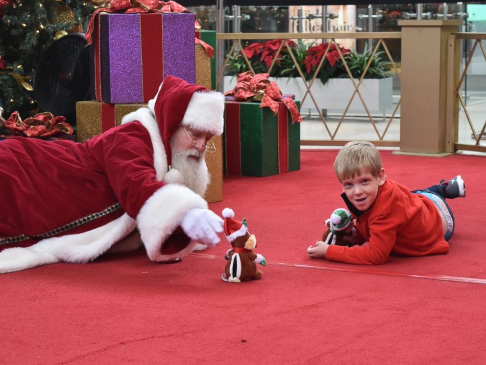 PHOTO: Brayden Deely, 6, took awhile to warm up to Santa so Santa got on the floor with him.