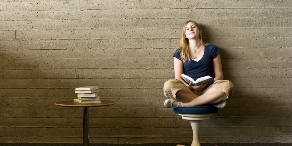 Young woman reading in a library