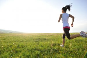 Runner athlete running on grass seaside