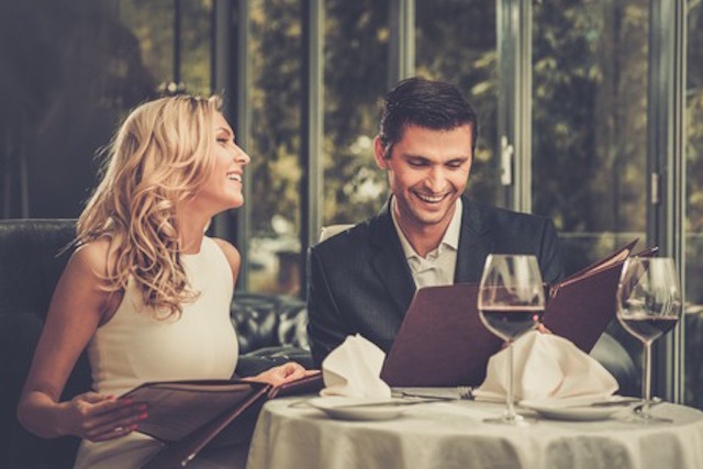 30356531 - cheerful couple with menu in a restaurant