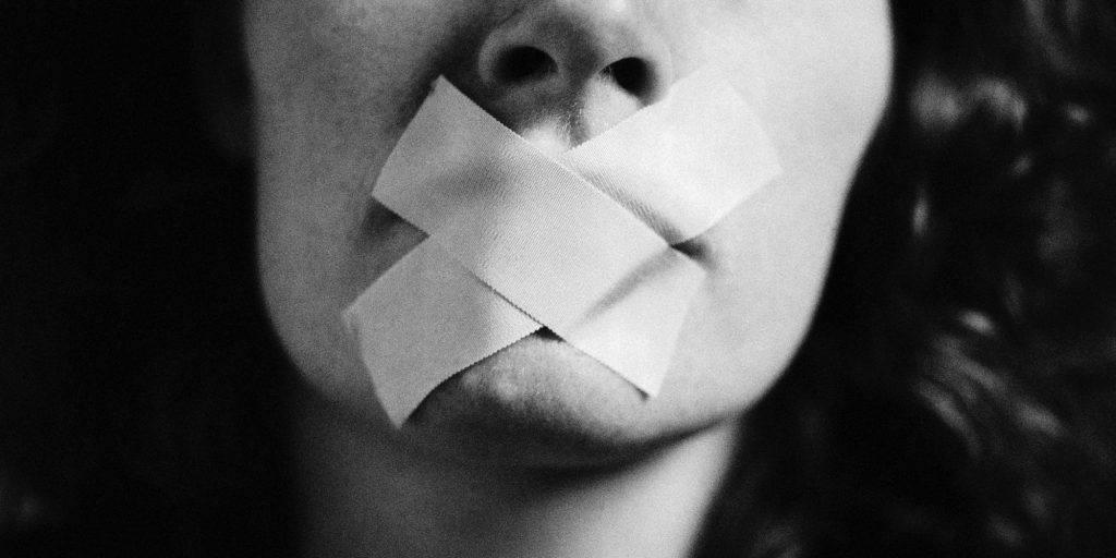 Gagged woman, close-up, blurred