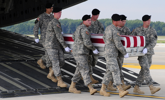 Soldiers from the 3d U.S. Infantry Regiment (The Old Guard), assist in a somber transfer of Sgt. James L. Skalberg Jr., 25, of Cullman, Ala., assigned to 4th Battalion, 1st Field Artillery Regiment, 3rd Brigade Combat Team, 1st Armored Division, Fort Bliss, Texas, and another Soldier, June 30, at Dover Air Force Base, Del.