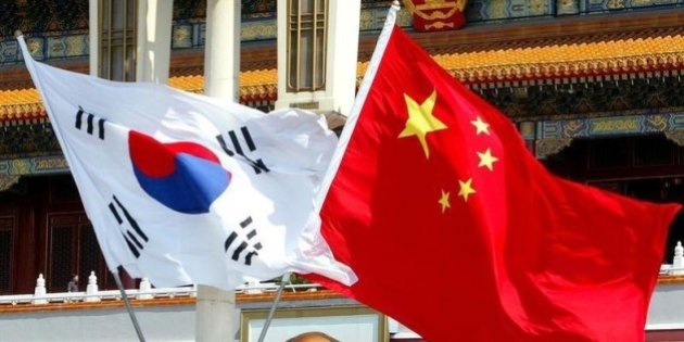 6月20日、浜田・イェール大学名誉教授ら18人が日中韓3カ国の関係改善を求める報告書を首相官邸に提出しようとしたところ、受け取りを断られていたことが明らかに。写真は中韓の国旗。北京で2003年7月撮影(2014年 ロイター)