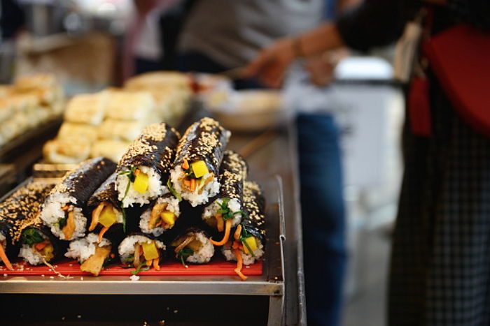Playful mother and daughters laughing in bedroom
