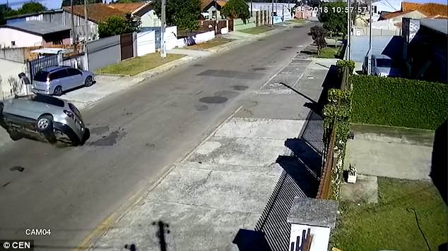 See you on the flip side: The stolen car is launched into the air after it crashes on a residential street in Brazil