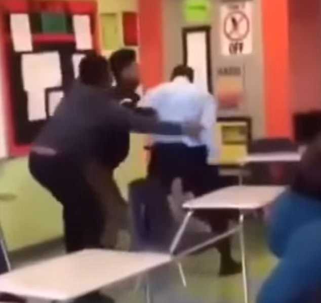 Students then intervened, two grabbing the teacher from behind to pull him awayÂ