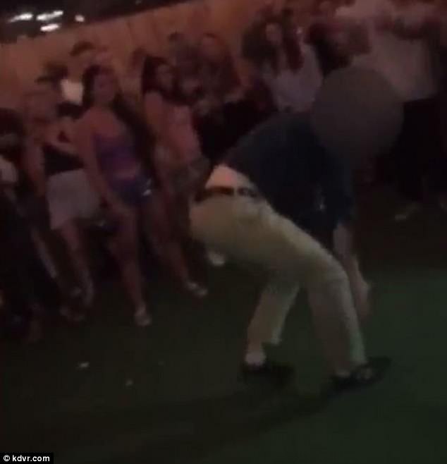 The FBI agent can be seen nonchalantly walking away, appearing not to be too concerned that his weapon just discharged inside a crowded bar