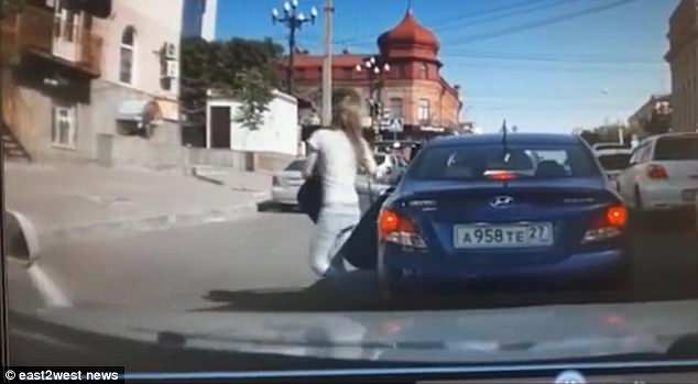 This is the horrific moment a spurned husband deliberately mowed down his wife after she told him wanted a divorce. The shocking incident was captured on camera in the city of Khabarovsk, eastern Russia