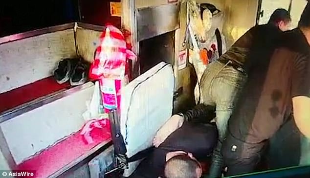 Mr Xie and one passenger rush to take control of the steering wheel and stop the bus aside