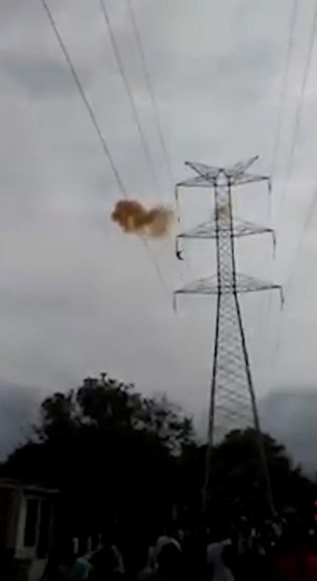 Pic shows: The moment Victor Jose Arroyo Gonzalez got electrocuted and fell off the tower. This is the tragic moment a deaf-mute young man fell more than 160 feet to his death from an electricity pylon when he touched live wires after giving up on his suicide bid. Victor Jose Arroyo Gonzalez, 20, had scaled the huge pylon in the city of Barranquilla in northern Colombia???s Atlantico department and threatened to throw himself off. But police officers and onlookers reportedly talked him out of killing himself and he had just started climbing back down when tragedy struck, according to reports. There was a huge flash and a cloud of smoke as the young man touched a live wire and he fell from near the top of the pylon. His limp body flipped around another cable lower down before somersaulting all of the way to the ground below as a crowd of onlookers screamed in horror. The disturbing scenes were captured on the smartphones of eyewitnesses in the Los Olivos area of the city. Mr Gonzalez had earlier been heard shouting: "I am going to throw myself off, I do not want to continue living anymore, I cannot cope anymore." He was declared dead at the scene. The deaf mute man was reportedly suffering from depression and had previously climbed tall structures to threaten suicide. Barranquilla, a port on the Caribbean Sea, is the only major city in South America that was populated before its formal foundation by Europeans. (ends)