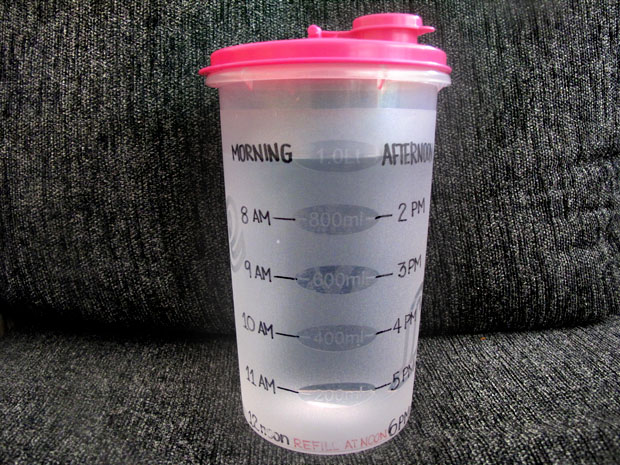 A water bottle marked with time to help you drink more water.