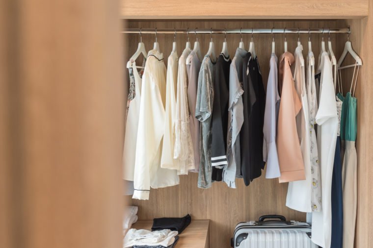 wooden closet with clothes hanging on rail, wardrobe interior design