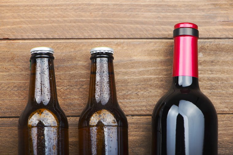 Top view of two beer bottles and a wine on wooden table