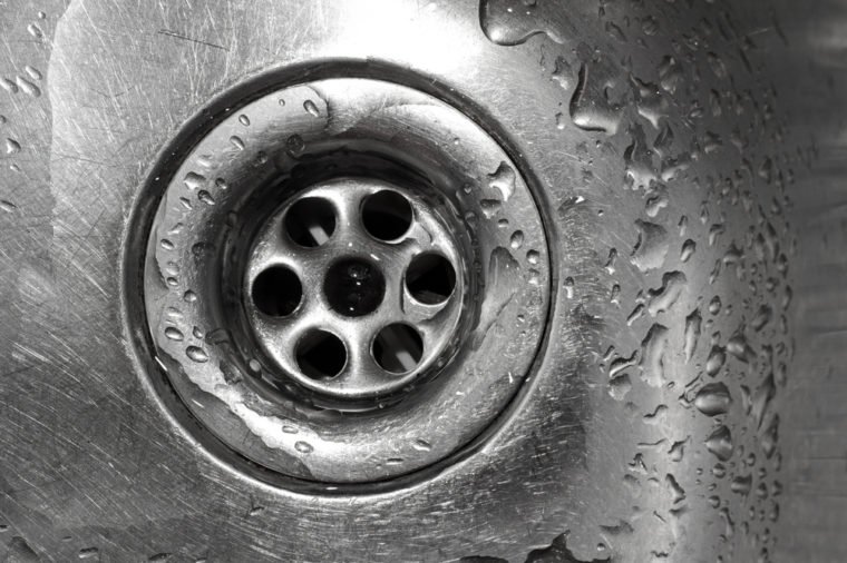 Metallic Kitchen sink with water drops shot from from above