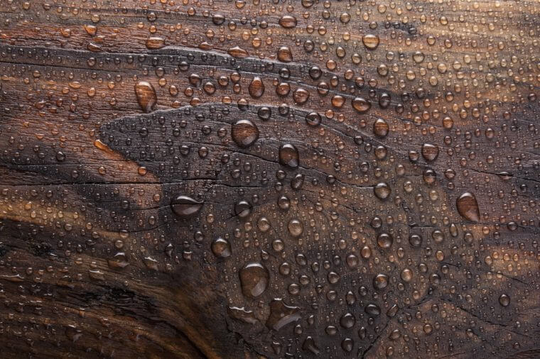 water drop in burn wooden background