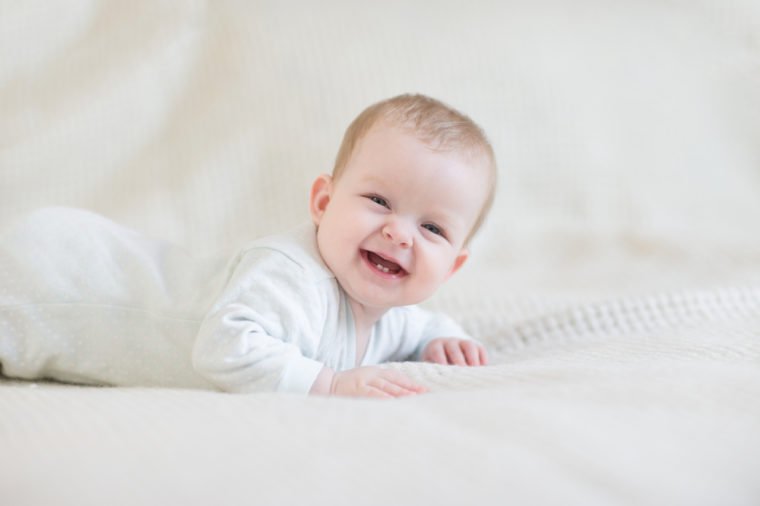 Laughing baby on bed