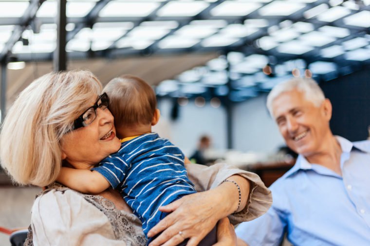 Grandparents With Their Grandson Spending Lovely Time At Cafe