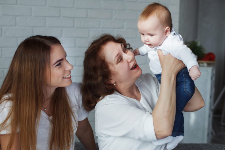 Portrait Mother, grandmother and baby are smiling and hugging. The concept of happy generations.