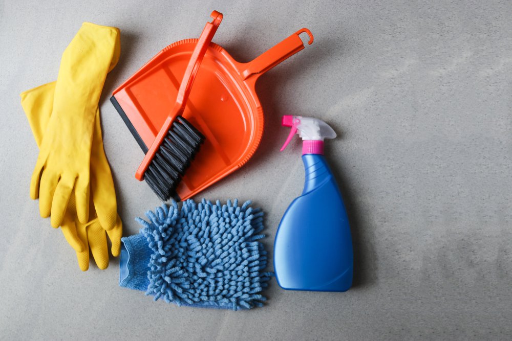 Bucket with sponges, chemicals bottles, brushes, towel and rubber gloves. Household equipment, spring-cleaning, tidying up, cleaning service concept, copy space.Cleaning products. Home cleaning concep