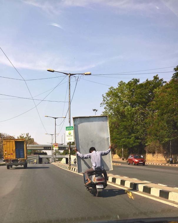 Umm... Not Sure Which Is Worse, The Guy Transporting Sheet Metal On The Scooter, Or The Unsecured Load In The Truck
