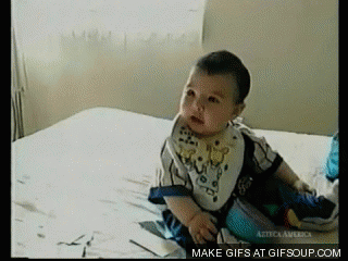 baby laughs and falls over gif