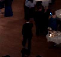 While the wedding guests were enjoying dancing their butts off, this kid was doing his own thing.