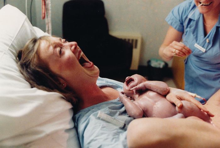 Moments After Giving Birth A Mother Laughs Hysterically At Her Husband Who Just Fainted At The Sight Of Their Newborn Son, 1986 Moments After Giving Birth A Mother Laughs Hysterically At Her Husband Who Just Fainted At The Sight Of Their Newborn Son, 1986