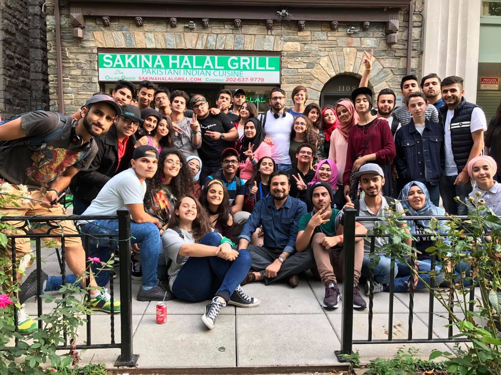 Image may contain: 35 people, people smiling, people sitting