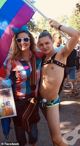 Image may contain: an androgynous man ,a girl, and man holding a flag