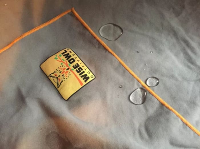 I recently spent four days camping on a beach. It was a great environment for morning swims and beach reading, but much less conducive to any fabric drying ever. Which is why I was so proud of myself for buying this Wise Owl Outfitters microfiber camping towel in anticipation of the trip. My boyfriend made fun of me a little because I guess BEING PREPARED IS LAME, but he sure changed his tune when our towels were the only ones that actually dried overnight. (They were dry enough to use again after about half an hour, but given the humidity it took longer for them to be like, British humor dry.)The other camp towels I've used have had the texture of public bathroom paper towels, so I was pleasantly surprised by how soft this one was. And speaking of texture, it didn't have that classic towel problem of trapping sand. I don't understand the science behind microfiber (or "the science," full stop), but this thing somehow manages both to repel water (see the above photo) AND dry me off with remarkable efficacy. Whatever, don't question it! Look, it even comes with a bonus mini towel!The towels also packed very small, which is perfect for camping, and also traveling generally. I tend to bring so much shit to the beach that by the time I have all my stuff together I'm like, "Should I just...stay home?" so I will absolutely be using this towel to lighten my load this summer. If you're camping, beaching, washing your dog, or going to one of those gyms where you have to pay extra for towels, do yourself a favor and buy one of these. —Jessie GaynorGet it from Amazon for .95+ (available in two sizes and three colors).