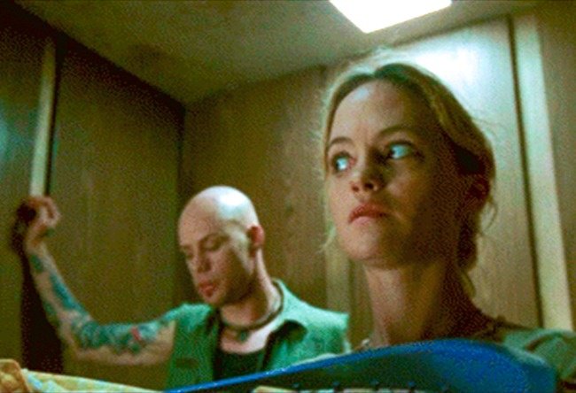 mujer en el elevador con un hombre sospechoso