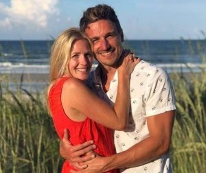 Image may contain: 2 people, people smiling, people standing, ocean, outdoor and water