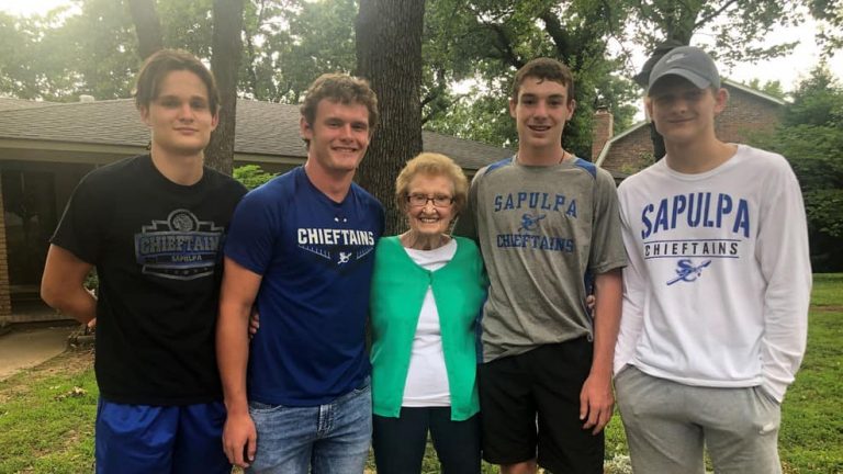 Image may contain: 5 people, people smiling, people standing and outdoor