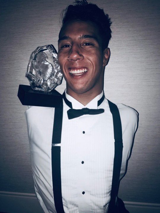 *** EXCLUSIVE - VIDEO AVAILABLE *** UNSPECIFIED - UNDATED: Gabe Adams with his Freedom Festival award. A MAN born with no limbs, who took up break dancing as a way of making friends, discovered he not only had a gift for it but that it could inspire others. Gabe Adams, 19, was born in Sao Paulo, Brazil with Hanhart syndrome, a rare medical condition characterised by underdeveloped limbs, mouth and jaw. In Gabe?s case none of his limbs grew at all. Adopted by American parents Janelle and Ron Adams, Gabe was brought to the US as a baby and grew up with his 13 siblings in Kaysville, Utah. From a young age Gabe started using a wheelchair but parents Ron and Janelle were determined that their son would be as independent as possible, pushing Gabe to learn to move independently of his wheelchair. At school he tried out for the dance team as a way of making friends ? discovering he could use his limbless body to his advantage in the art of break dancing. After graduating from high school Gabe has continued to prove his independence, moving out of the family home and embarking on a career as a motivational speaker. PHOTOGRAPH BY Barcroft Images