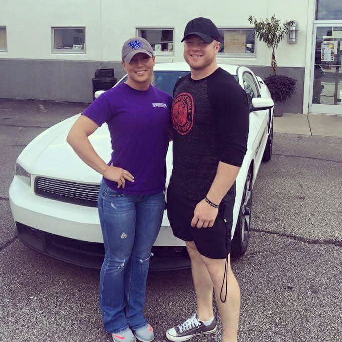 Image may contain: 2 people, people smiling, people standing