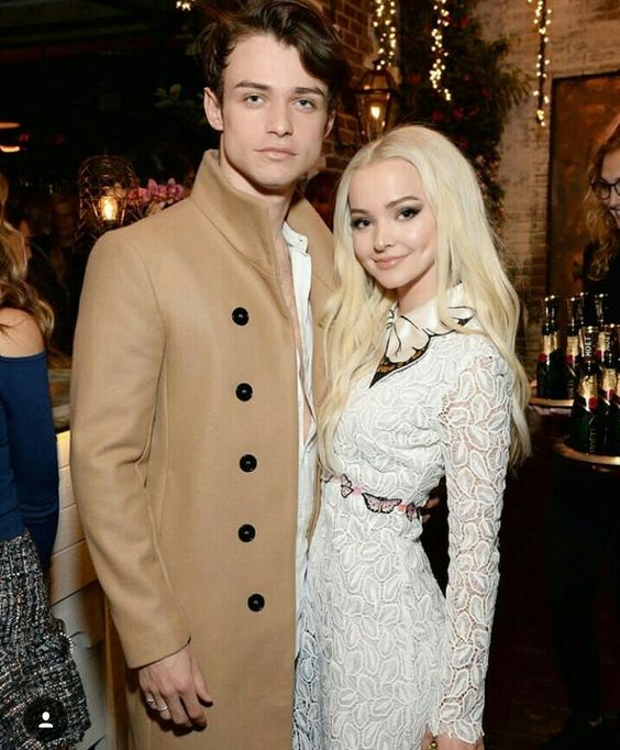 Dove Cameron y Thomas Doherty posando abrazados para la página