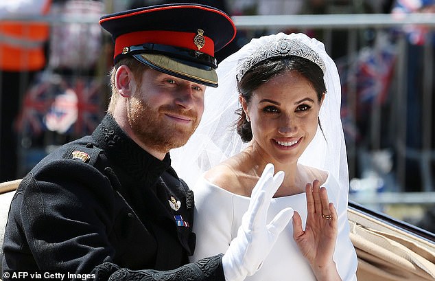Prince Harry and wife Meghan waving after their wedding ceremony in Windsor in May 2018