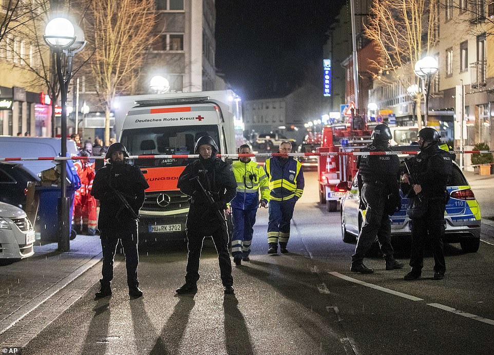 Police guard the scene in front of a restaurant in central Hanau after the drive-by shooting