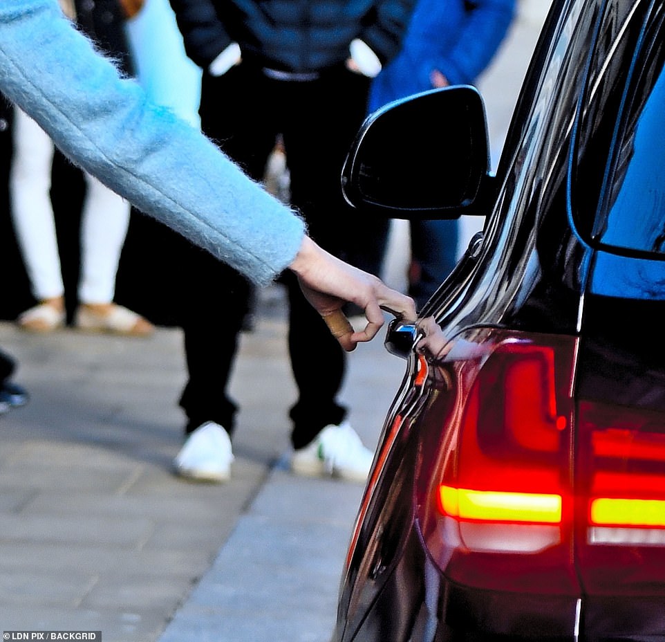 Taking control: The Duchess did not need the help of her security team as she opened her car door