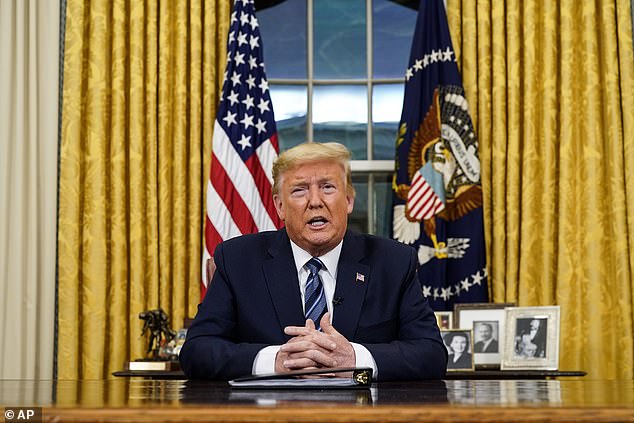 Power of the office: Donald Trump spoke from behind the Resolute desk, in front of the United States flag, the presidential seal, and pictures of (from left) his mother Mary Anne, father Fred, and a picture of himself with a young Ivanka on his lap