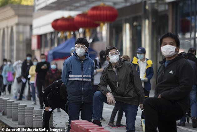 Patients wait in line outside the fever clinic of Wuhan Union Medical College Hospital for nucleic acid detection in Wuhan, Hubei Province