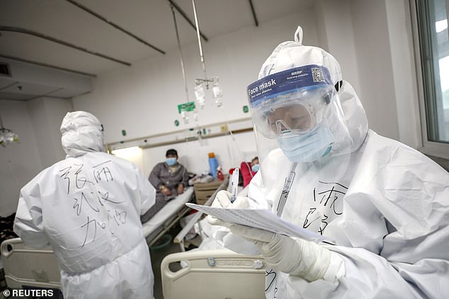 At least 46,000 people have died of COVID-19 and more than 917,000 have been infected worldwide. A medical worker is pictured checking a patient