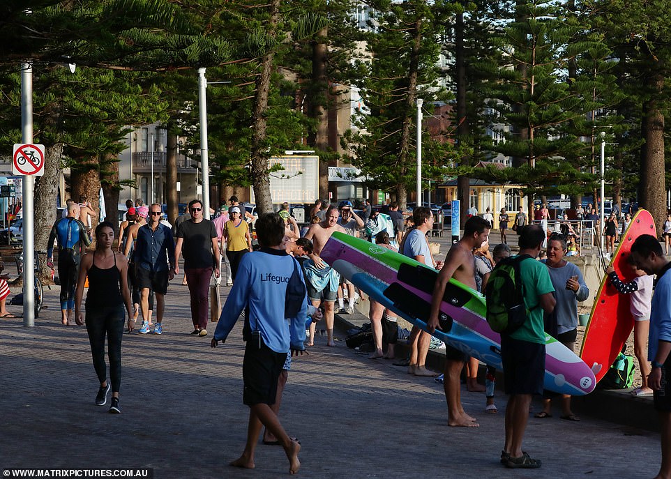 Beachgoers and residents seeking their daily dose of exercise were packed together on the boardwalk