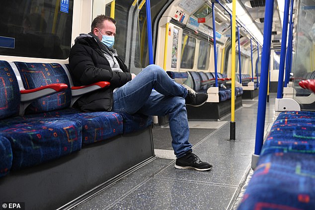 The UK Government has long held the view that the cheap paper masks offer little protection against catching COVID-19. A passenger on the London Underground wears one last month