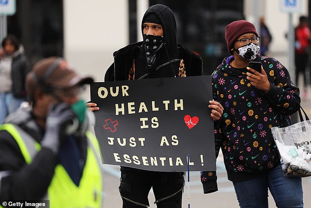 Amazon employees above hold a protest and walkout over conditions at the company