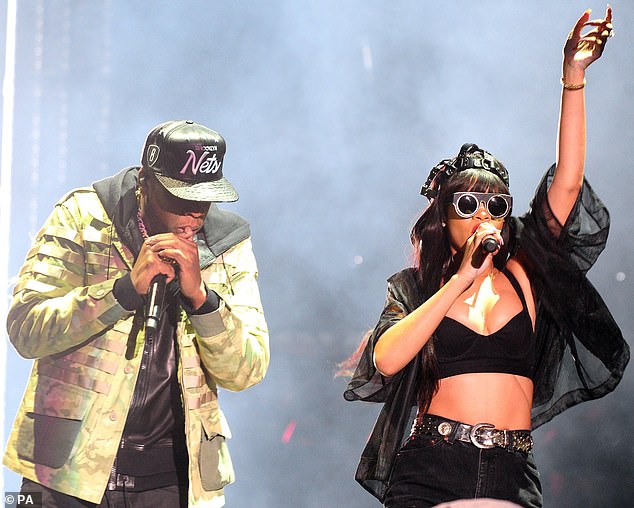 Doing their bit: Rihanna has teamed up with Jay-Z and Twitter CEO Jack Dorsey to donate .2 million to coronavirus relief efforts; the two performers are pictured onstage in London in 2012